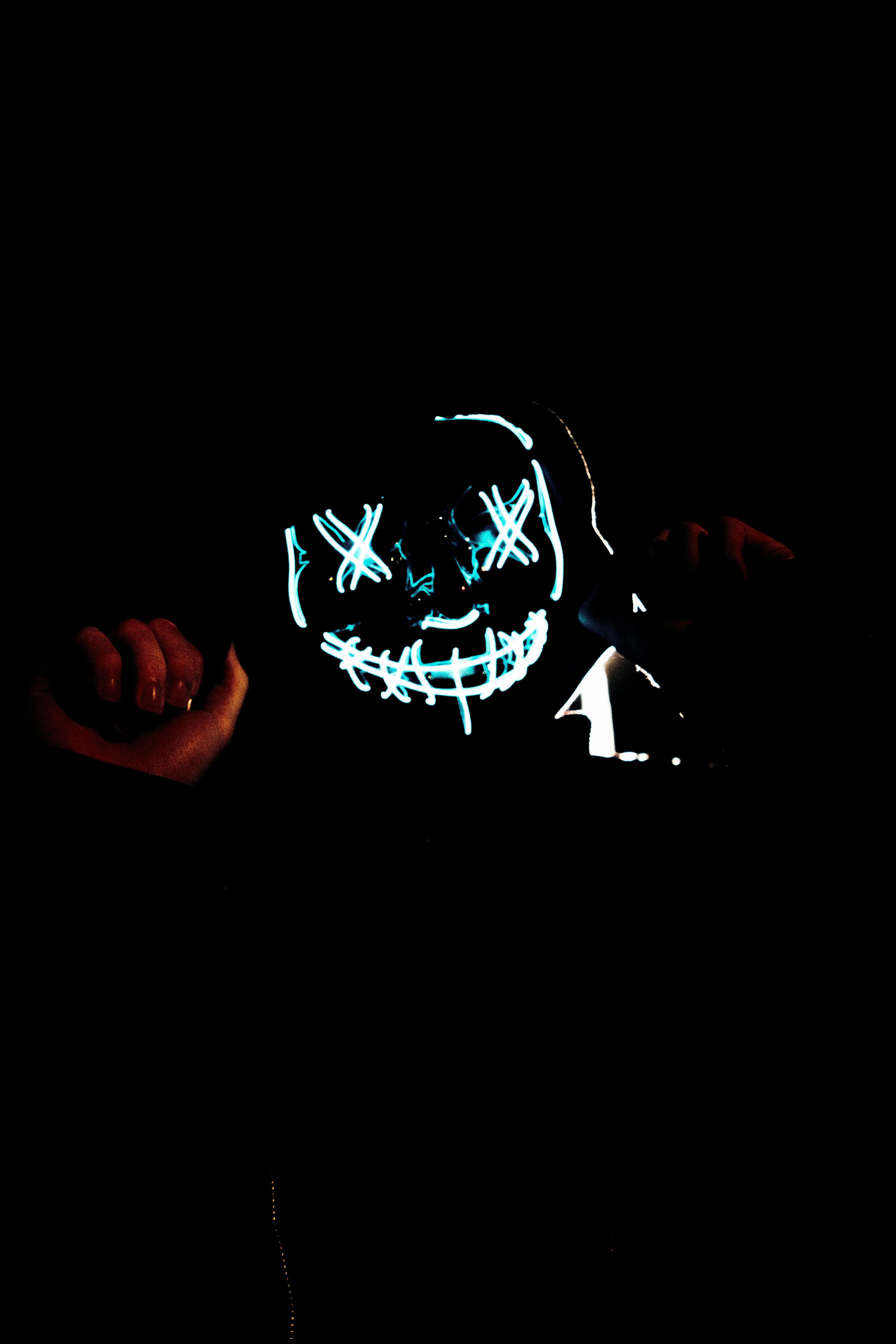 person holding white and black heart shaped neon light